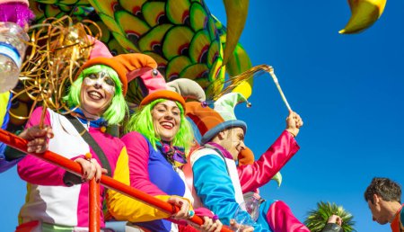 Photo for Viareggio, Italy - February 10, 2013: People with colorful costumes dancing on a Float at the famous Carnival parade. - Royalty Free Image