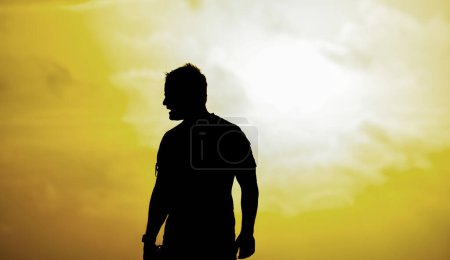 Photo for Silhouette of a man looking to the sea on the beach. - Royalty Free Image