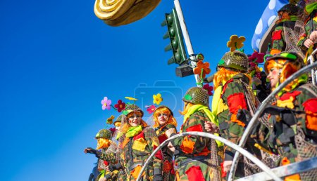 Téléchargez les photos : Viareggio, Italy - February 10, 2013: People with colorful costumes dancing on a Float at the famous Carnival parade. - en image libre de droit