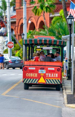 Foto de Key West, FL - February 21, 2016: City orange trolley is a famous tourist attraction. - Imagen libre de derechos