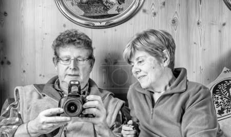 Photo for Happy smiling senior family couple in love looking at camera pictures together. Retired husband and wife enjoying life. - Royalty Free Image