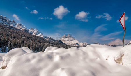 Photo for Mountain peak and snowy valley in winter season against a beautiful sunny blue sky. - Royalty Free Image