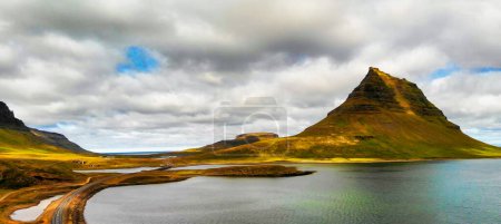 Photo for Famous Icelandic mountain Kirkjufell with lake and ocean on the background. Kirkjufell mountain on the Snaefellsnes Peninsula in summer season from drone viewpoint. - Royalty Free Image