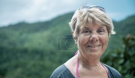 Photo for Elderly woman happy visiting a tropical island. - Royalty Free Image