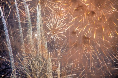 Photo for New Year's Eve fireworks. Gold and dark blue Fireworks and bokeh and copy space. Abstract background holiday. - Royalty Free Image