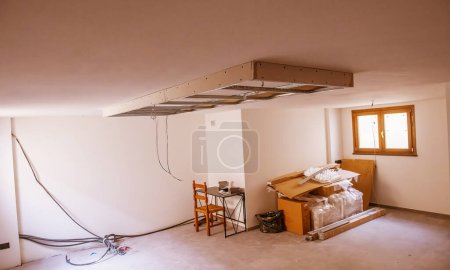 Photo for Finishing works in a new house. Suspended Ceilings. Drywall ceiling preparation for led lightin - Royalty Free Image