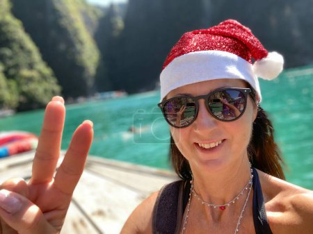 Photo for Family Tropical Christmas. Happy caucasian woman wearing Christmas Hat on a beautiful beach. - Royalty Free Image
