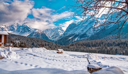 Téléchargez les photos : Mountain peak and snowy valley in winter season against a beautiful sunny blue sky. - en image libre de droit