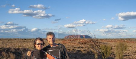 Photo for Portrait of a happy caucasian couple hiking along the australian outback on a beautiful sunny day. - Royalty Free Image