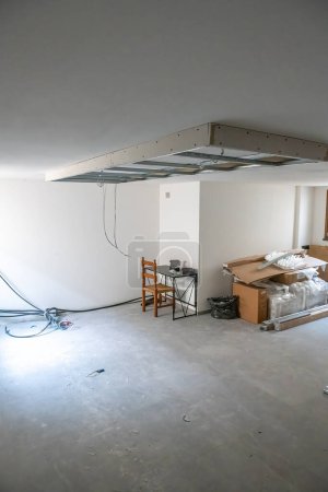 Photo for Finishing works in a new house. Suspended Ceilings. Drywall ceiling preparation for led lightin - Royalty Free Image