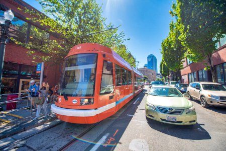 Photo for PORTLAND, OR - AUGUST 18, 2017: City traffic on a beautiful sunny day. Red tram and cars - Royalty Free Image