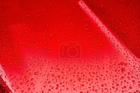 Photo for Raindrops on the red body of a car. - Royalty Free Image