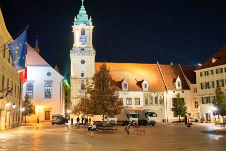 Photo for Bratislava, Slovakia - August 23, 2022: Tourists at night along the major city square. - Royalty Free Image