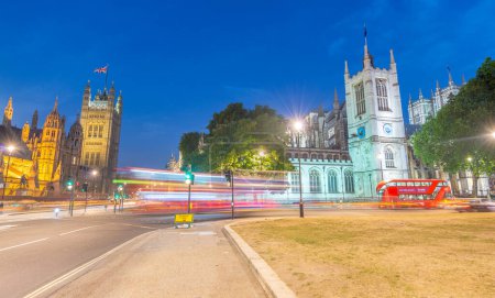 Photo for LONDON - JUNE 2015: Traffic along Westminster area at night. London attracts 30 million people annually. - Royalty Free Image