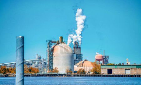 Photo for Industrial facility. Exterior of modern petrochemical plant with reactors and converters. Smoke from the chimney - Royalty Free Image