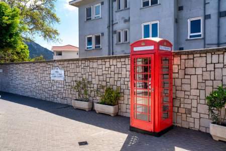 Photo for Iconic british old red telephone box at the entrance in Gibraltar. - Royalty Free Image