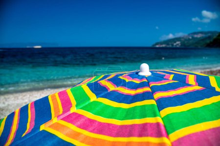 Photo for A colourful umbrella on the beach. - Royalty Free Image