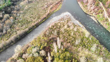 Photo for Overhead aerial view of a river across a valley - Drone viewpoint. - Royalty Free Image