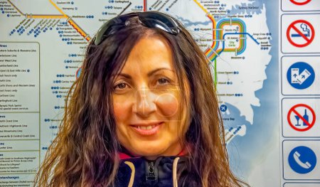 Photo for Portrait of a happy caucasian woman visiting a city with subway map on the background. - Royalty Free Image