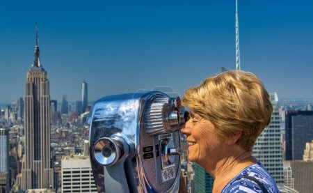 Photo for A happy elderly woman looking at New York panorama. - Royalty Free Image