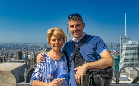 Photo for A happy man with his mother looking at New York panorama. - Royalty Free Image