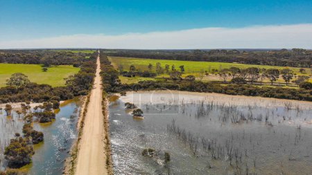 Photo for Kangaroo Island unpaved road along lake and trees, aerial view from drone - Australia. - Royalty Free Image