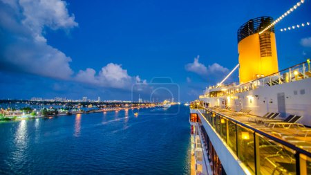 Photo for A cruise ship arriving in the city at night. - Royalty Free Image