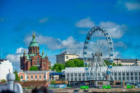 Photo for Helsinki, Finland - July 4, 2017: Uspenski Cathedral and Ferris Wheel. - Royalty Free Image