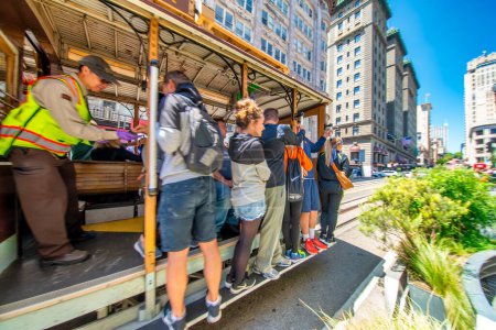 Photo for San Francisco, CA - August 6, 2017: City tram and buildings on a sunny day. - Royalty Free Image