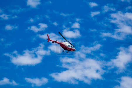 Photo for Helicopter flying in the blue sky. - Royalty Free Image