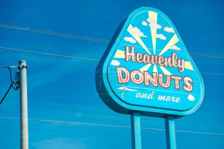 Photo for Portland, Oregon - August 19, 2017: Heavenly Donuts ads against blue sky. - Royalty Free Image