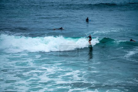 Photo for San Diego - July 28, 2017: Surfers ride the wave in La Jolla Beach. - Royalty Free Image