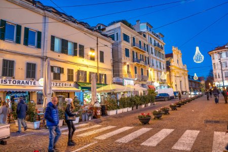 Photo for Sanremo, Italy - December 30, 2023: City streets at night with tourists. - Royalty Free Image