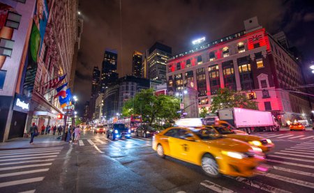 Photo for New York City - June 2013: City streets and buildings at night. - Royalty Free Image