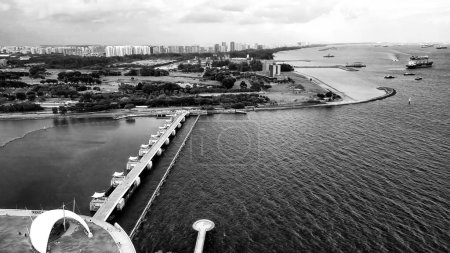 Marina Barrage, Singapore: Aerial view of cityscape and coastline on a overcast afternoon.