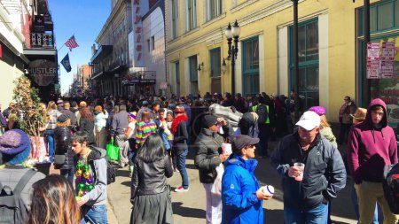 Photo for New Orleans, LA - February 9, 2016: Crowd of tourists and locals along the city streets for Mardi Gras event. - Royalty Free Image