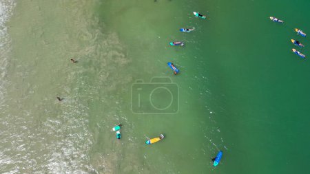 Photo for Aerial view of Surfers finding waves in Lombok, Indonesia. - Royalty Free Image