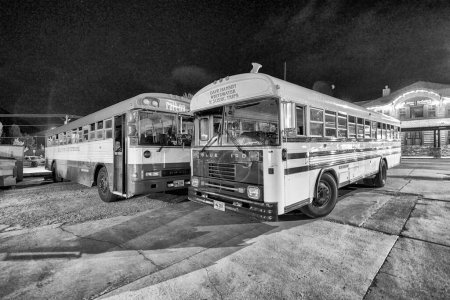 Photo for Jackson Hole, WY - July 10, 2019: Public buses at the parking at night. - Royalty Free Image