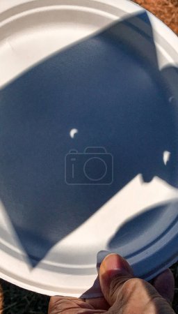 Photo for Solar Eclipse. The sun shadow reflected on a plastic dish. - Royalty Free Image