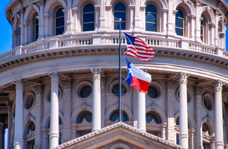 Photo for American and Texas state flags flying on the dome of the Texas State Capitol building in Austin. - Royalty Free Image