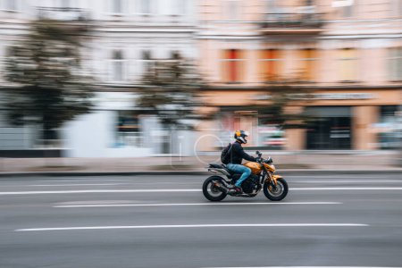 Photo for Ukraine, Kyiv - 2 August 2021: Yellow motorcycle moving on the street. Editorial - Royalty Free Image