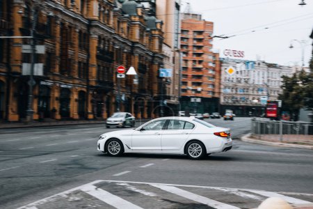 Photo for Ukraine, Kyiv - 2 August 2021: White BMW 5 Series car moving on the street. Editorial - Royalty Free Image