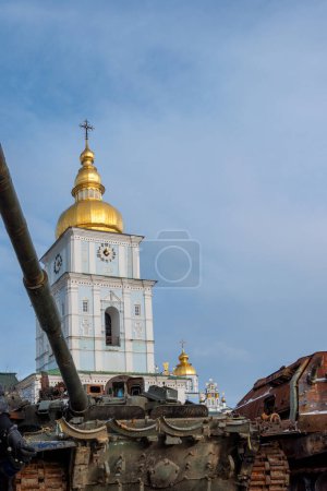 Photo for KYIV UKRAINE - 07 JANUARY 2023: Captured russian tank and other destroyed military vehicles during Russian invasion of Ukraine in 2022. St Michael's Golden-Domed Monastery on background. Editorial - Royalty Free Image