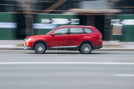 Photo for Ukraine, Kyiv - 7 January 2023: Red Mitsubishi Outlander car moving on the street. Editorial - Royalty Free Image