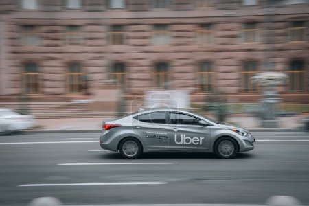 Photo for Ukraine, Kyiv - 2 August 2021: Silver Uber Taxi Hyundai Elantra car moving on the street. Editorial - Royalty Free Image