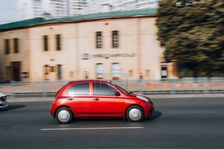 Photo for Ukraine, Kyiv - 16 Jule 2021: Red Nissan Micra car moving on the street. Editorial - Royalty Free Image