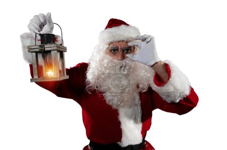 Photo for Uncertain santa claus with a vintage lantern - Royalty Free Image