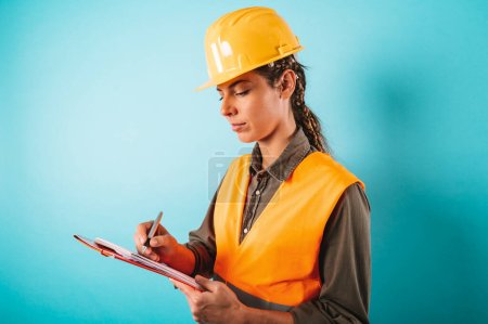 Photo for Woman with helmet and jacket who work in a warehouse - Royalty Free Image