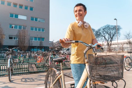 Téléchargez les photos : Fille prend un vélo loué dans un parking à vélos - en image libre de droit