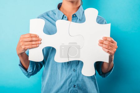 Photo for Woman holds a puzzle as concept teamwork, partnership and integration - Royalty Free Image